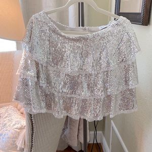 White blouse, silver miniskirt set.